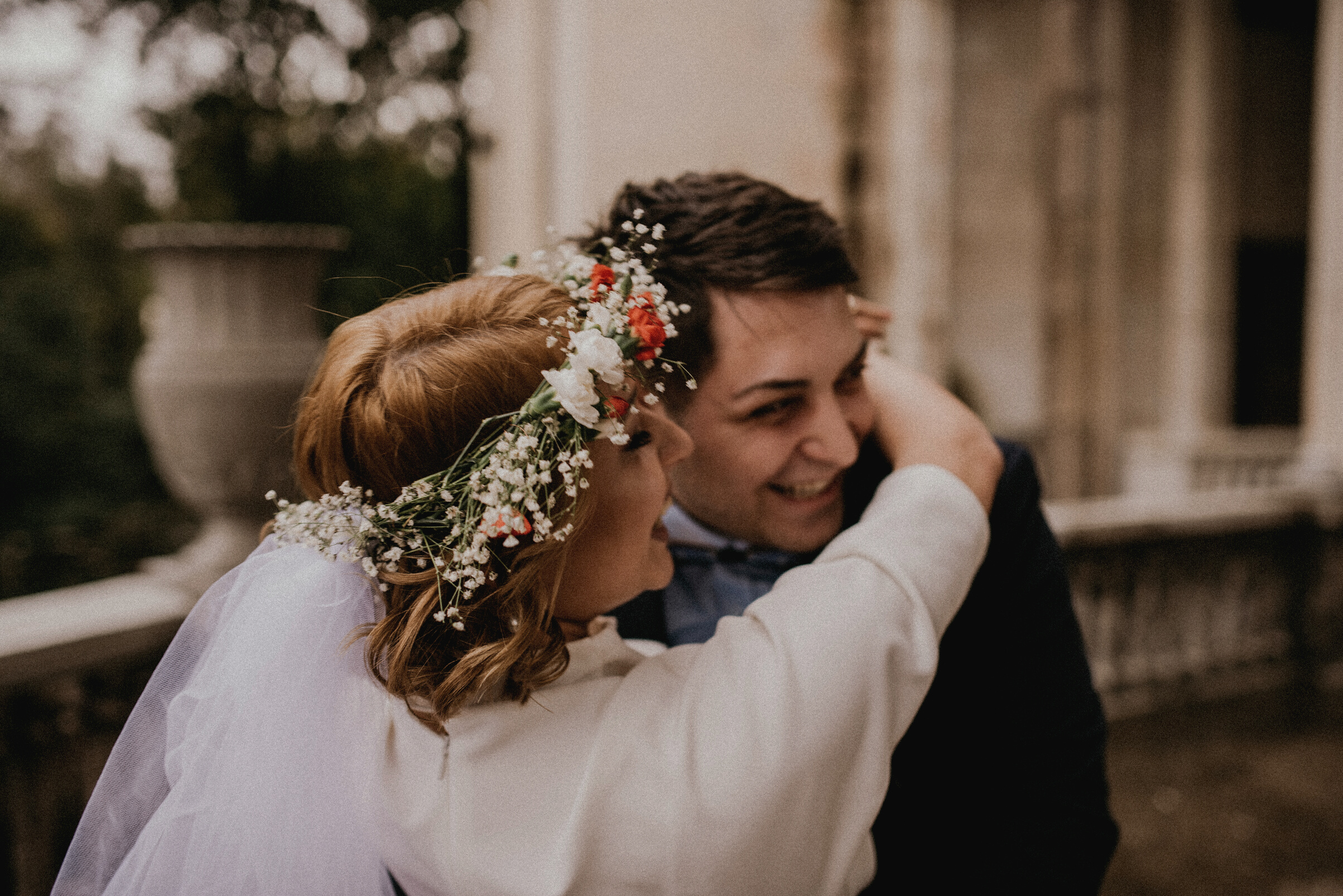 Bride in White Dress Hugging Her Groom